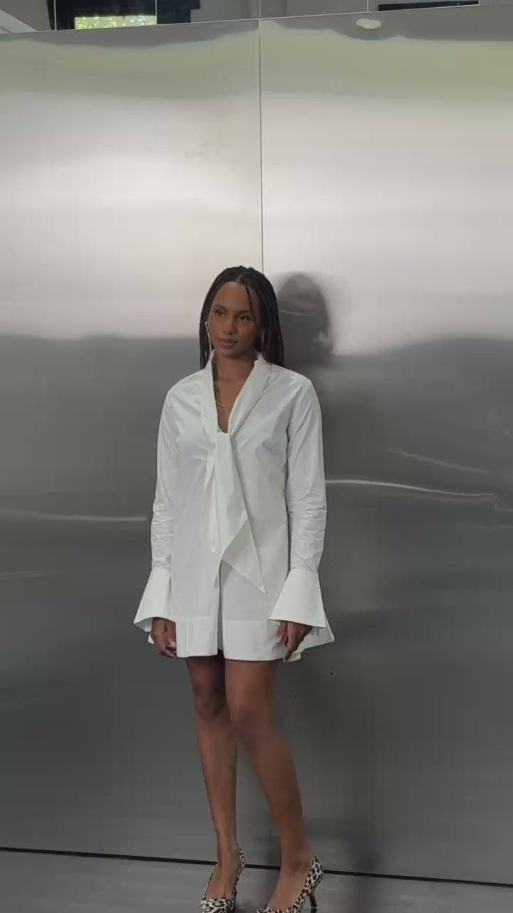 Video of the SHÉ White Cotton Baby Doll Tie Dress in white cotton showing movement and the multi-way neck tie