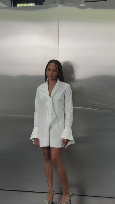 Video of the SHÉ White Cotton Baby Doll Tie Dress in white cotton showing movement and the multi-way neck tie